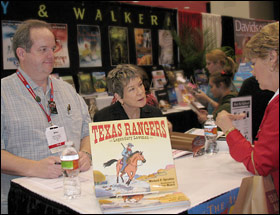 Artist Roxie Munro and Mike Spradlin sign for Texas Librarians at the 2009 TLA show